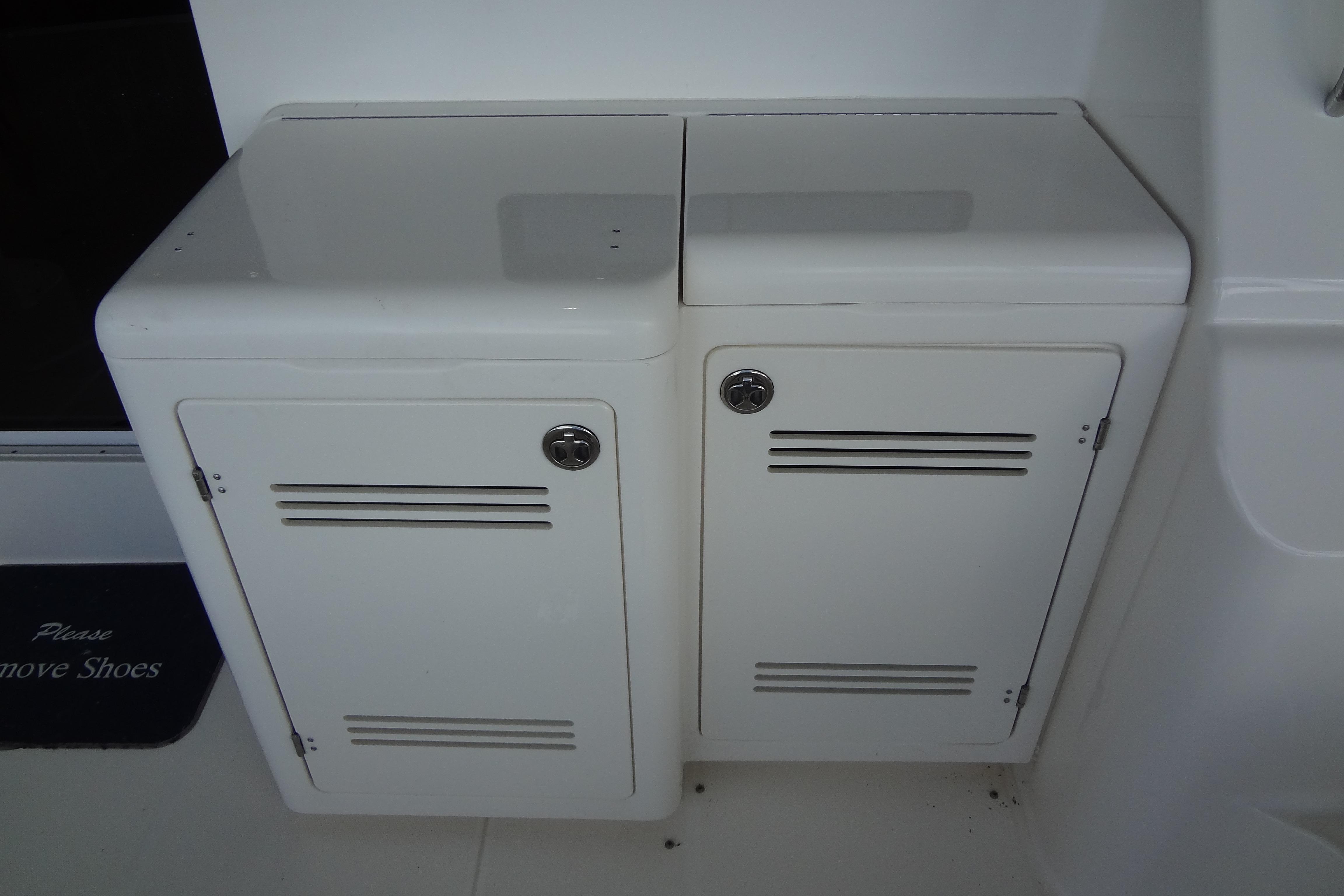 White storage cabinets on a 2005 Silverton 34 Convertible boat deck.