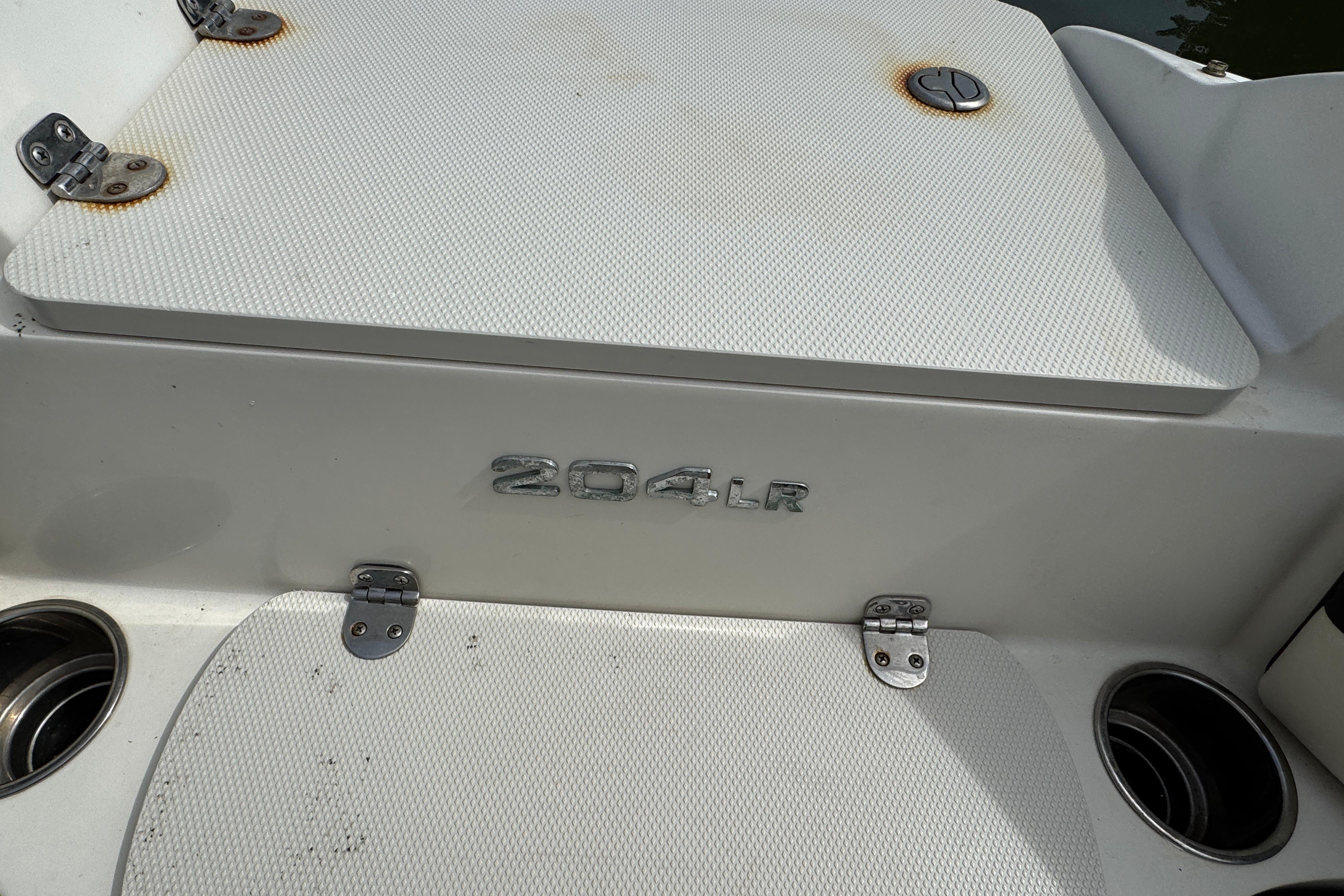 2018 Stingray 204 LR boat deck with cup holders and storage compartments.