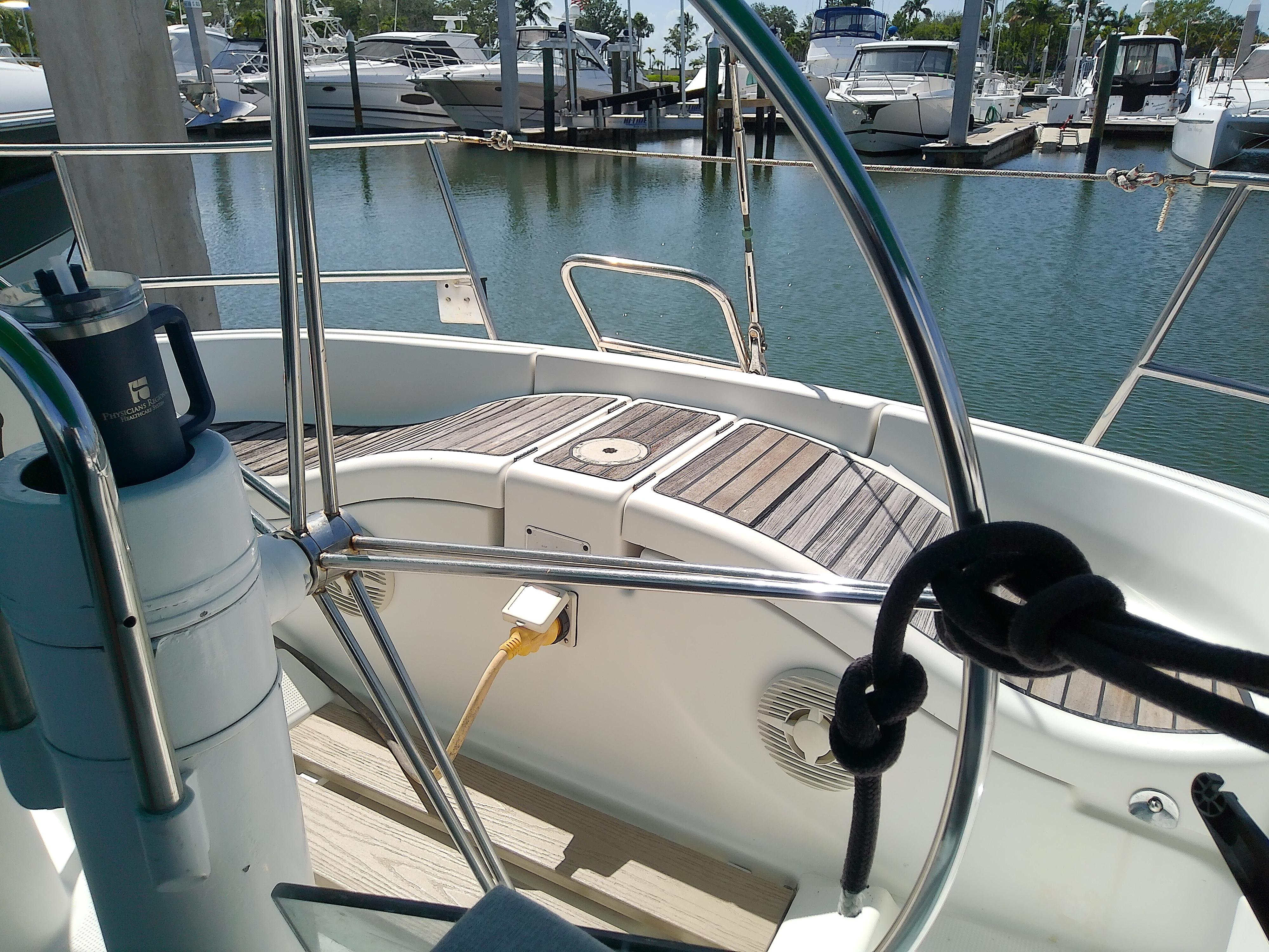 Cockpit view of a 1995 Beneteau First 42s7 sailboat docked at a marina.