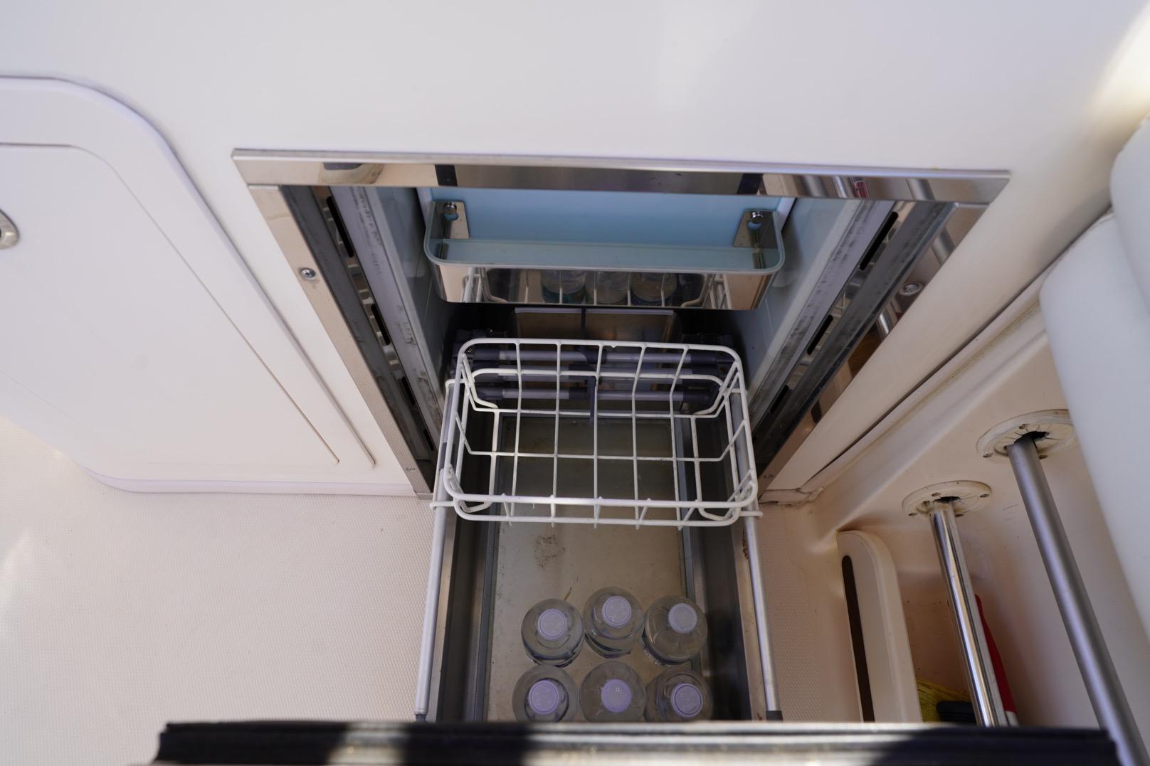 Built-in cooler on 2015 Grady-White Freedom 307 boat with water bottles inside.