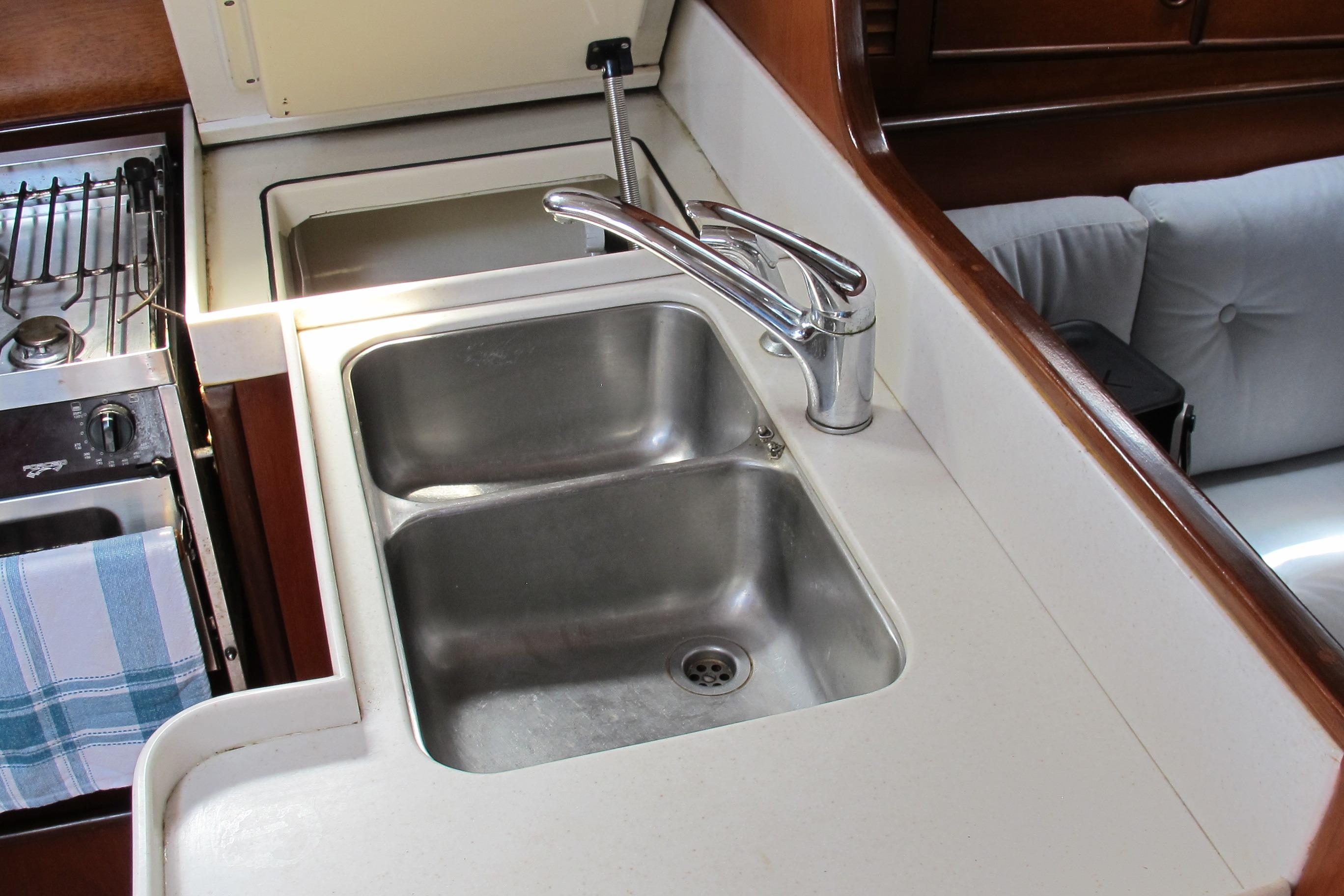 Galley sink and stove in 1985 Beneteau Idylle 11.50 yacht interior.