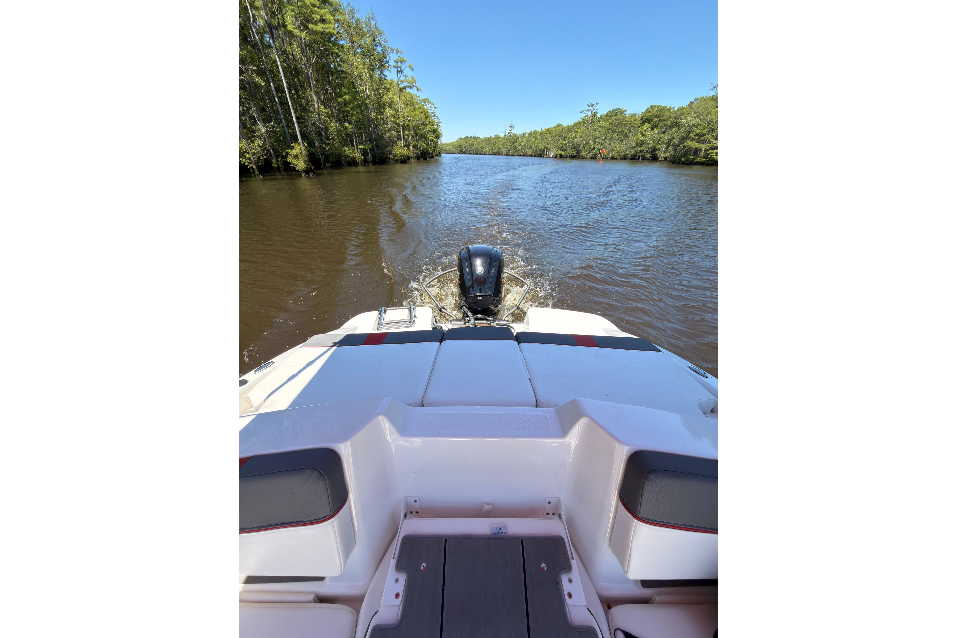 2022 Tahoe T18 boat cruising on a scenic river with lush greenery.