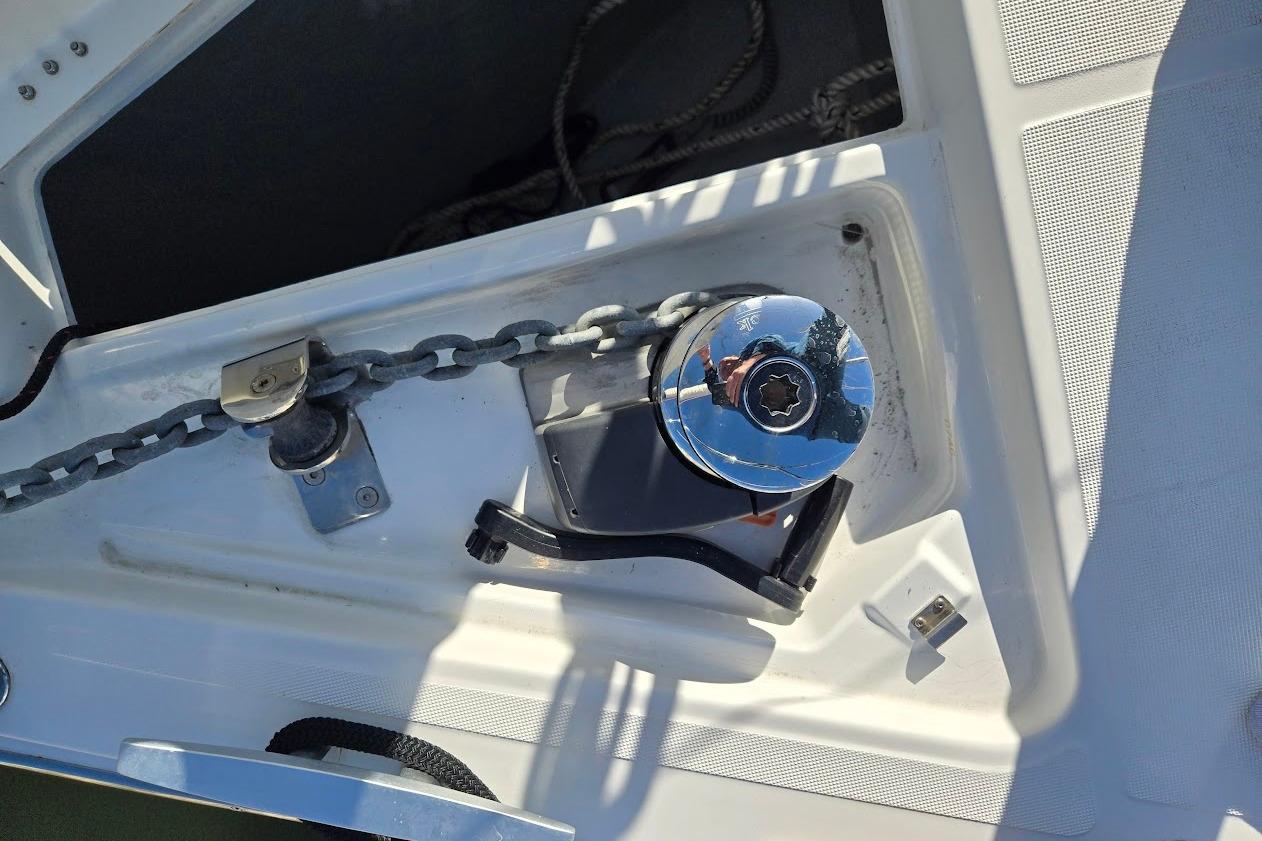 Anchor chain and winch on 2023 Beneteau Oceanis 38.1 yacht deck.