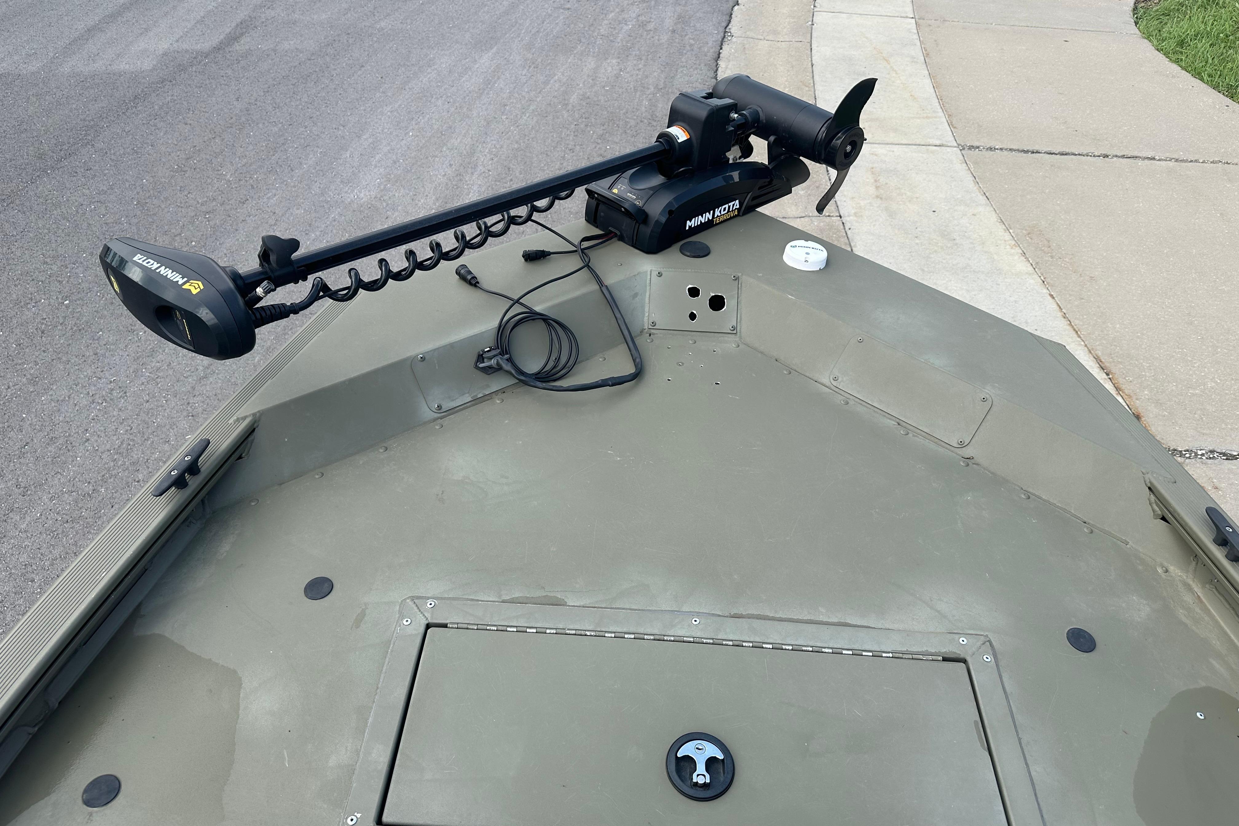 2024 Tracker Grizzly 1648 SC boat with Minn Kota trolling motor on deck.