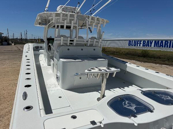 2022 Freeman 42LR boat at Bluff Bay Marina, featuring spacious deck and fishing rod holders.