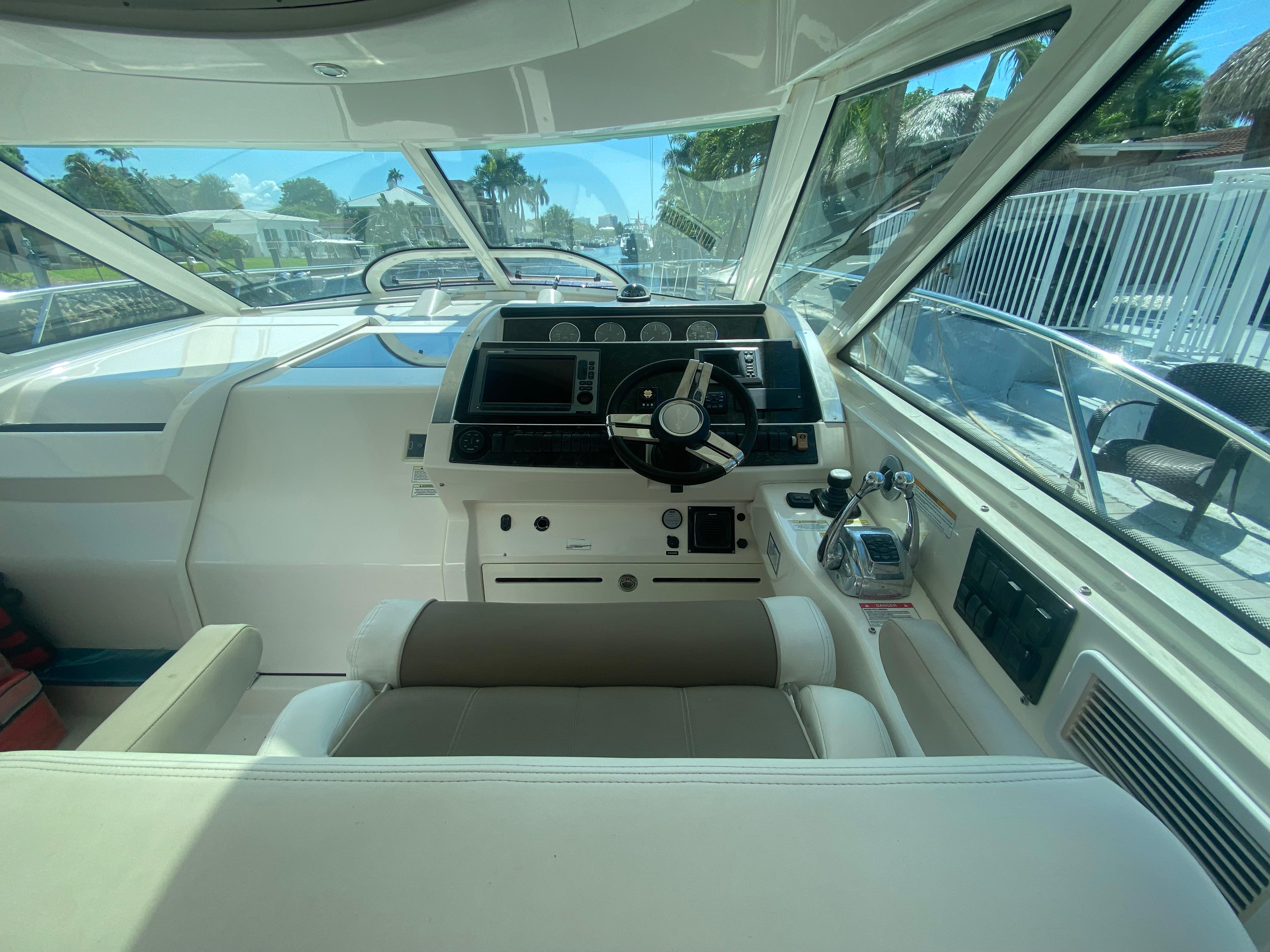 Helm of 2012 Sea Ray 450 Sundancer yacht with modern controls and panoramic view.