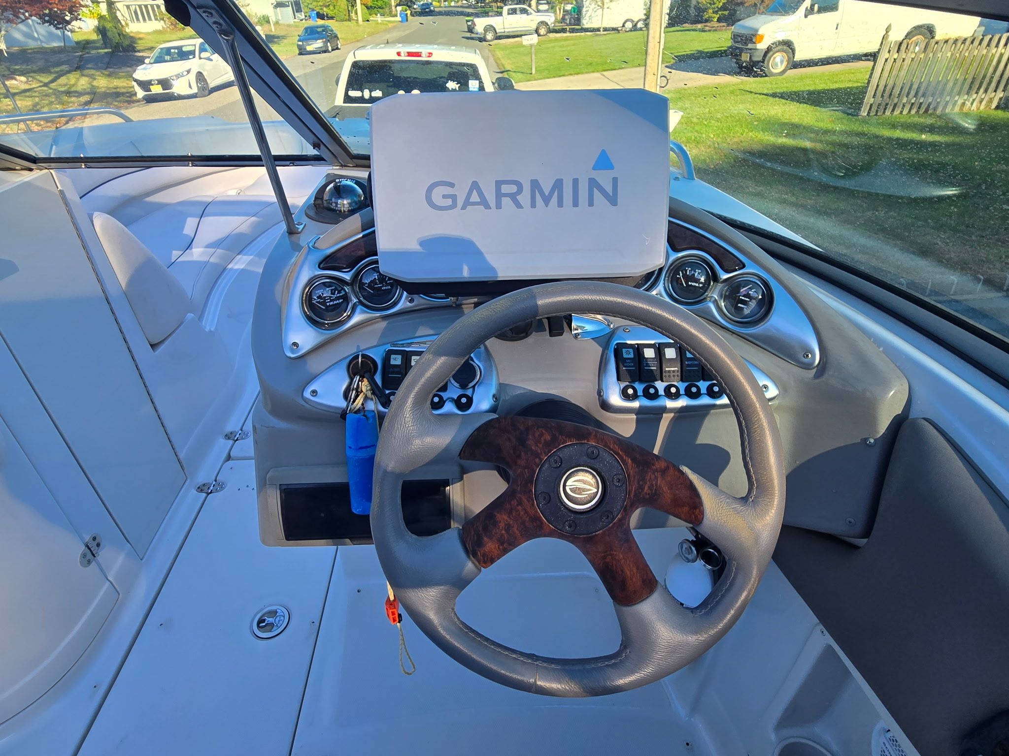 The image shows the cockpit of a 2005 Crownline 240 EX boat with a Garmin navigation system.