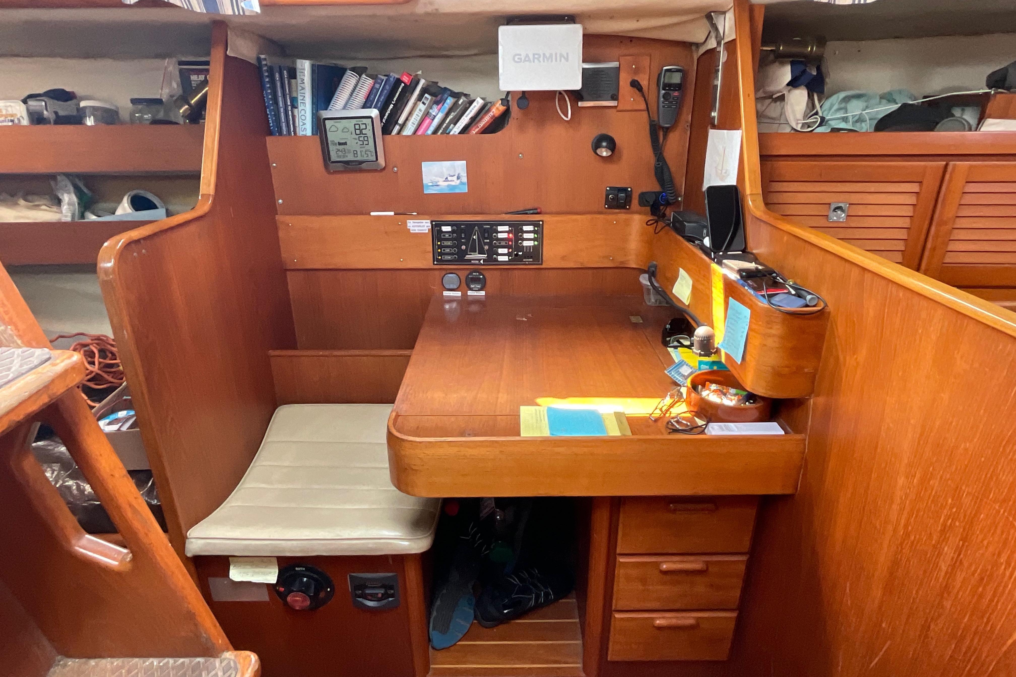 Navigation station inside 1988 Westerly Corsair 36 sailboat, featuring wooden desk and equipment.