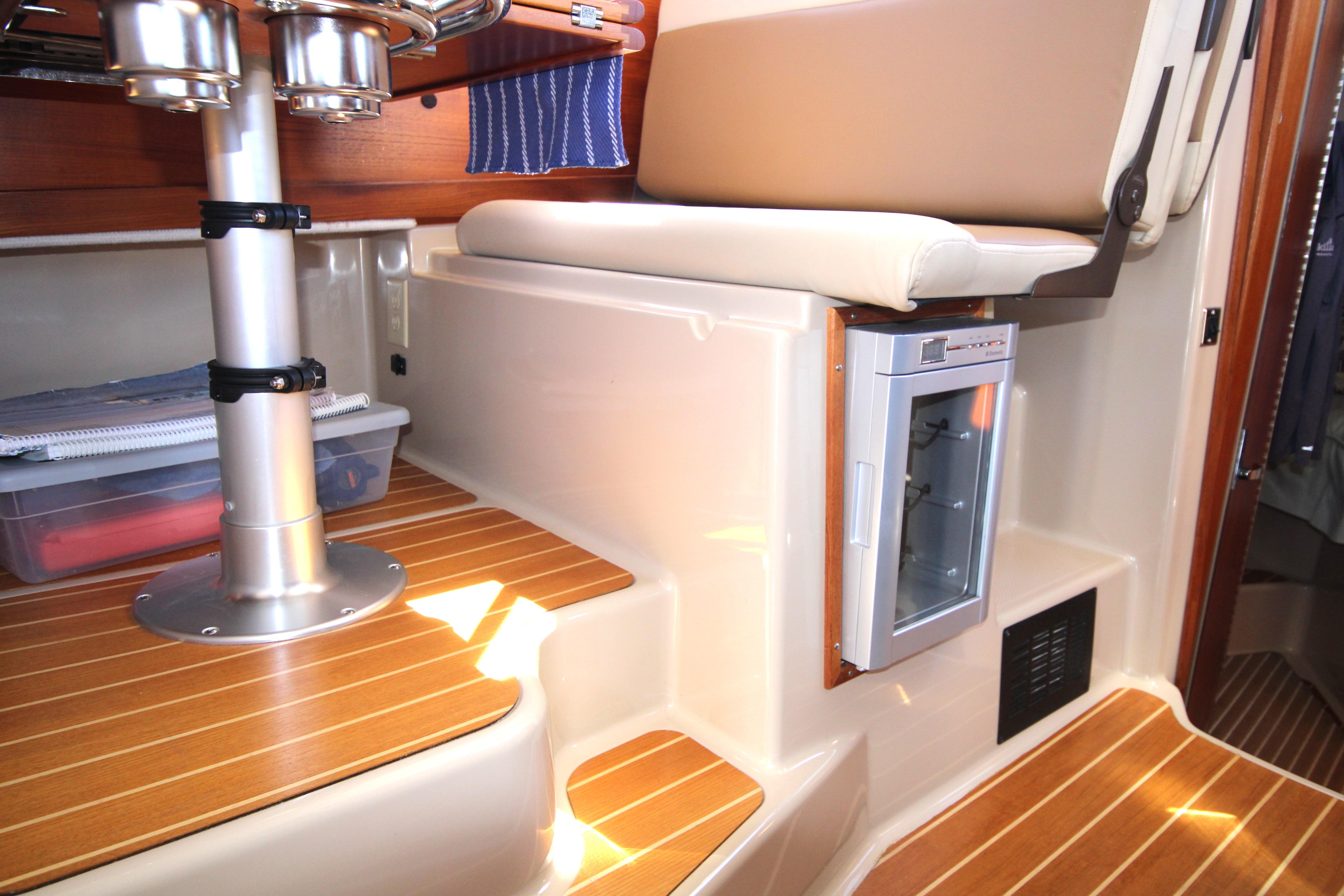 2013 Ranger Tugs R-31 CB interior with seating and compact refrigerator.