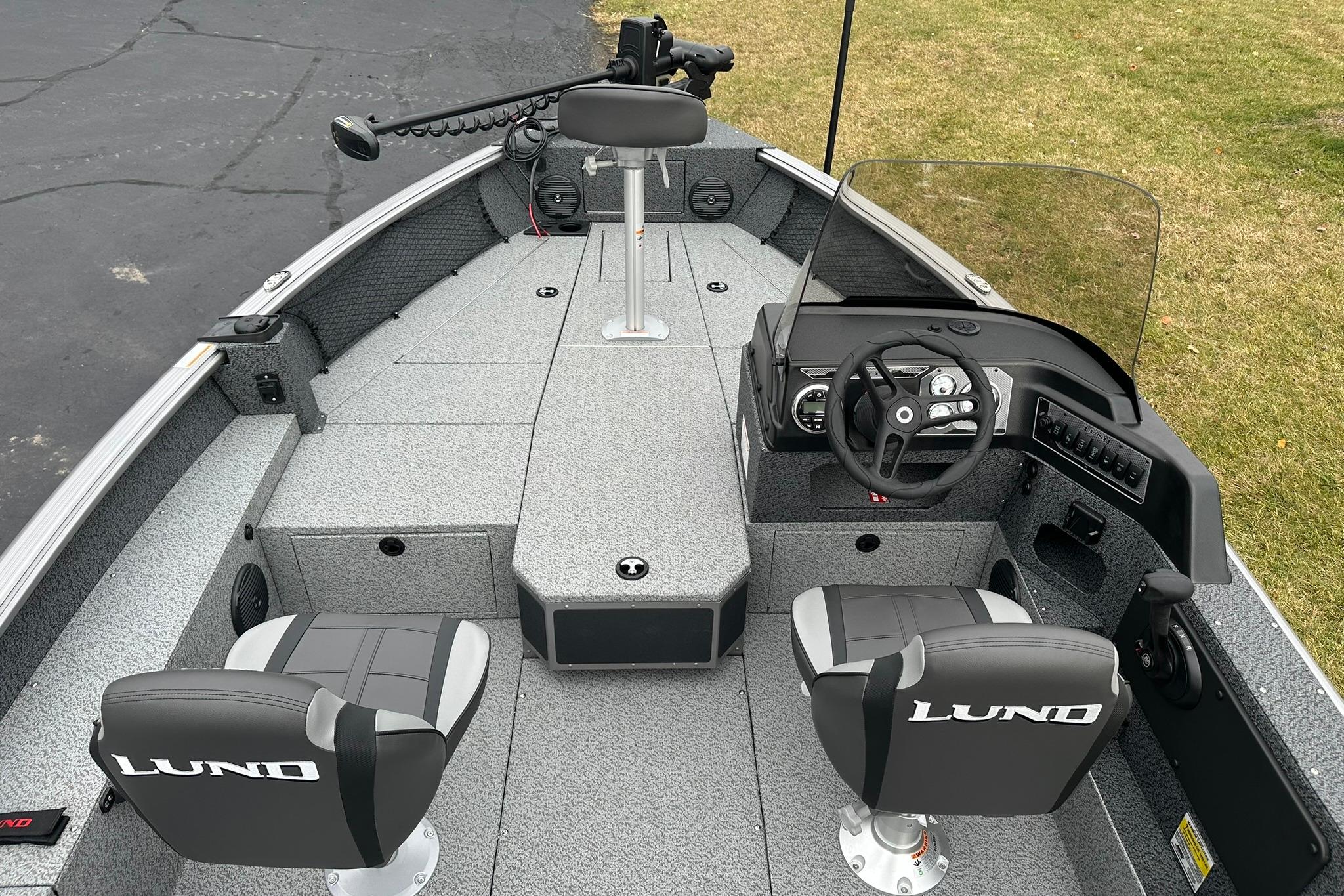 2026 Lund 1875 Impact XS SS boat interior with steering console and seating.