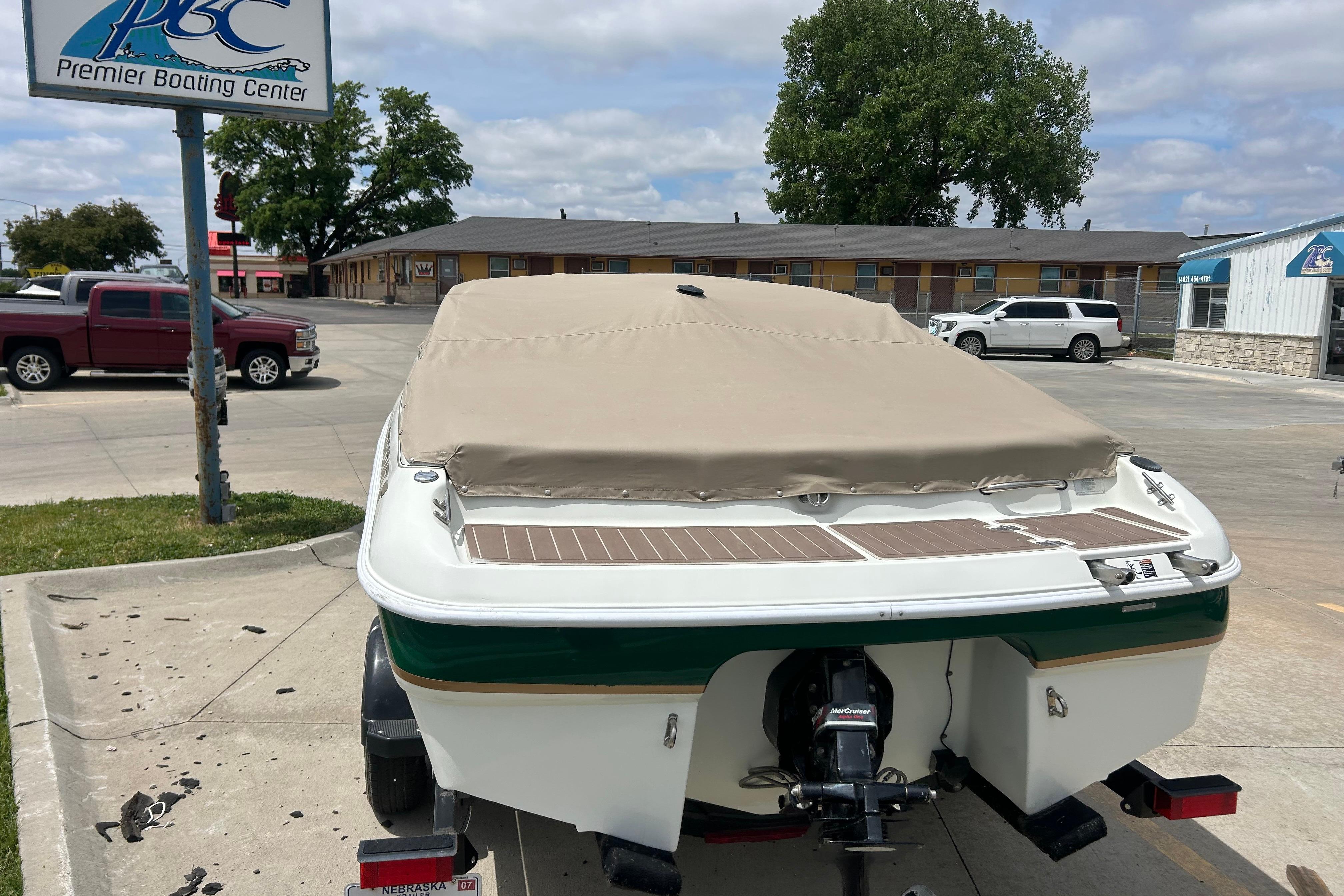 Covered 2000 Starcraft 1810 boat at Premier Boating Center parking lot.