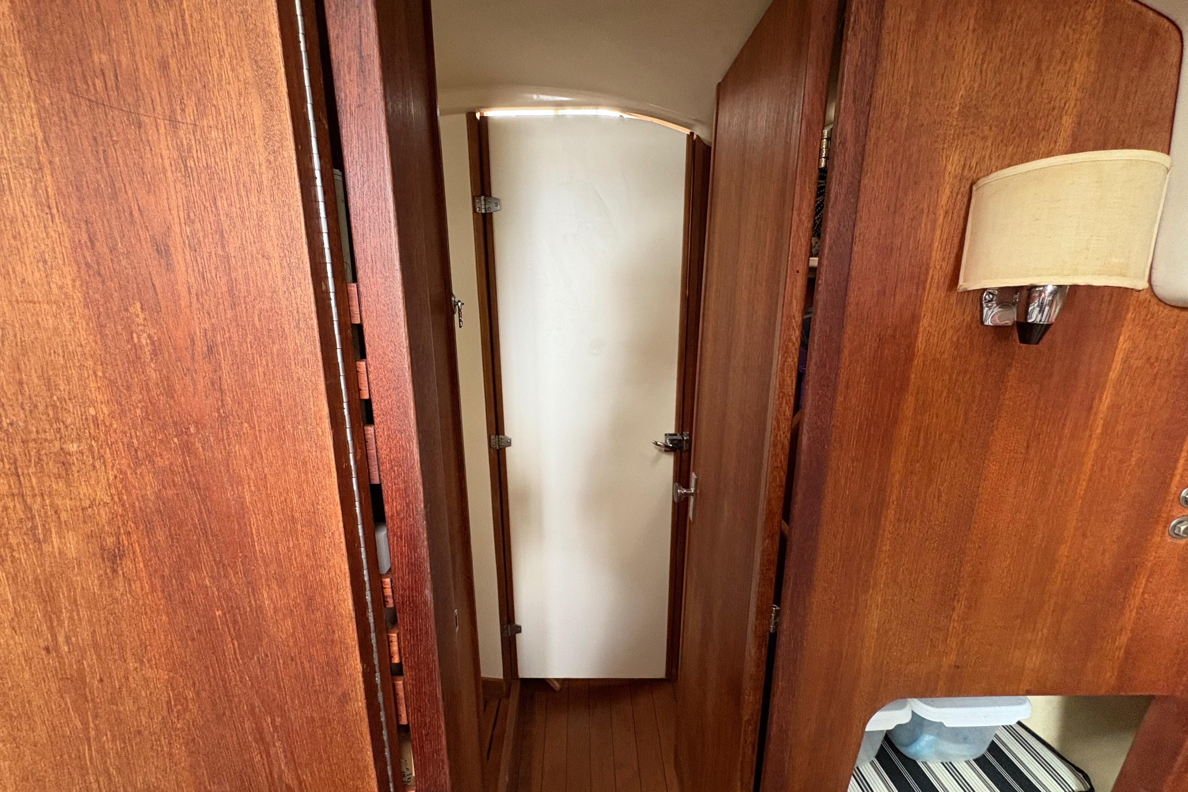 Interior of 1981 Sabre 31 sailboat with wooden paneling and a white door.
