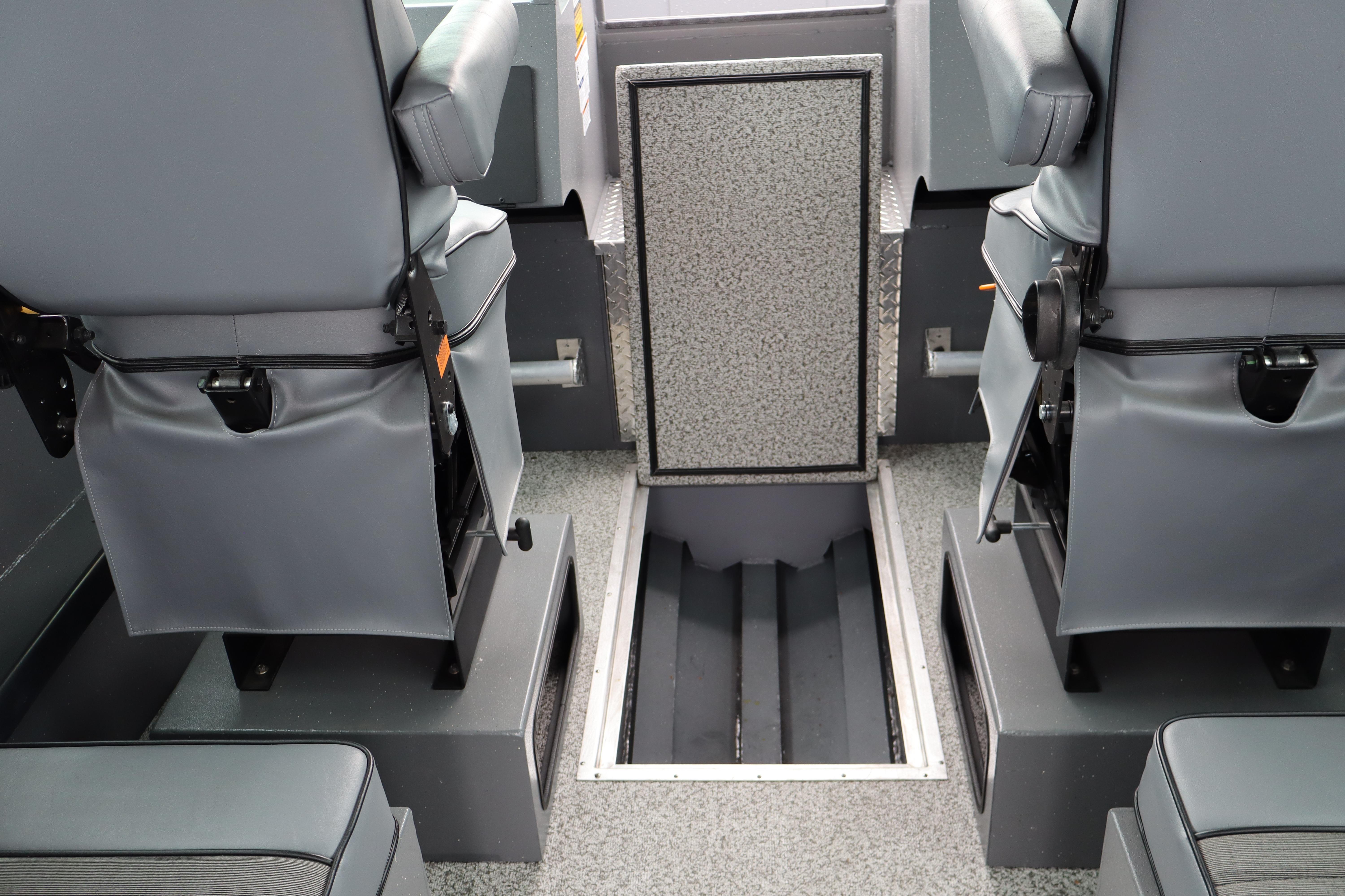 Interior of 2026 Alumaweld Horizon 24 boat with gray seating and storage compartments.