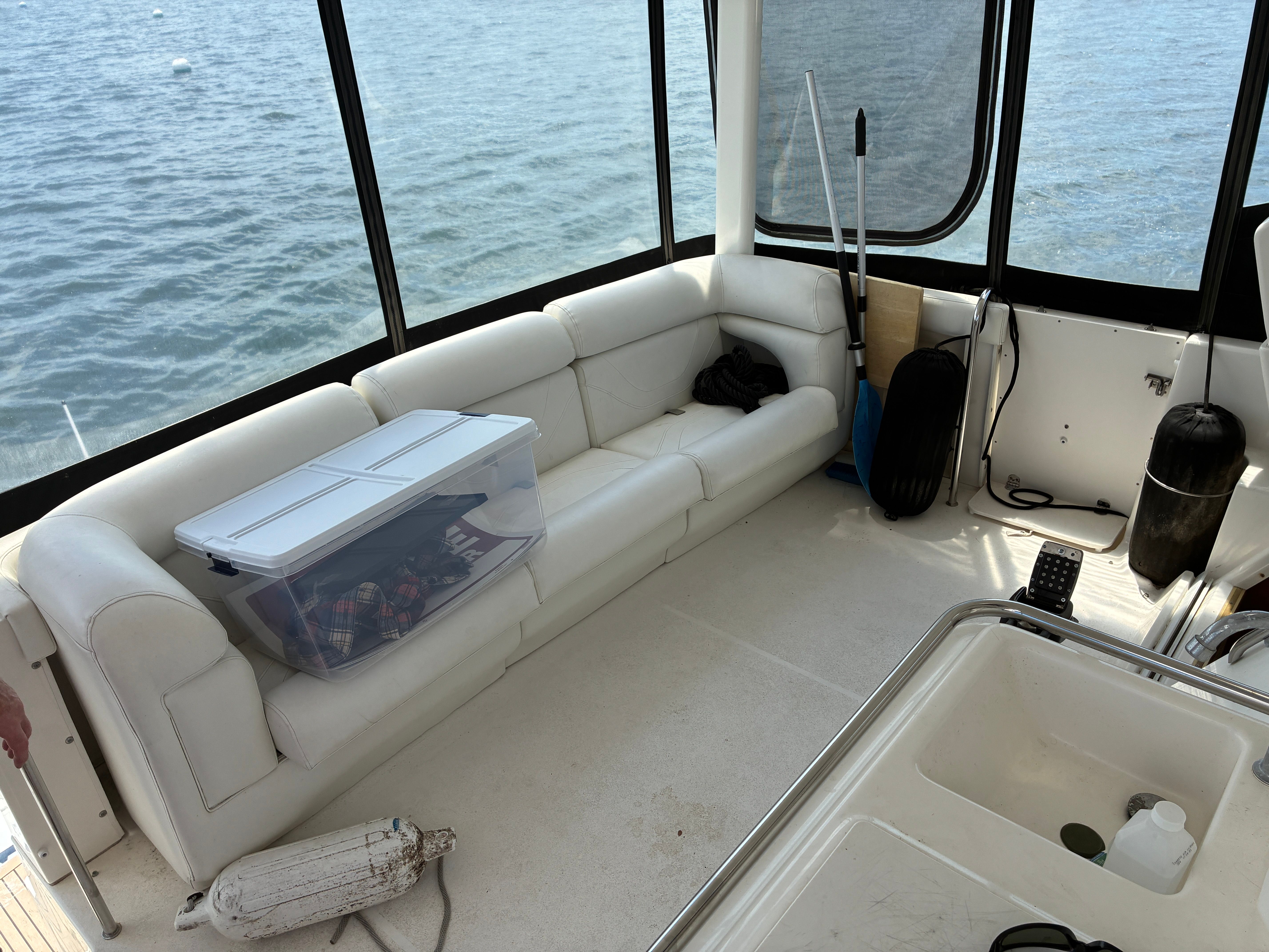Interior of a 2001 Silverton 392 Motor Yacht with white sofa and view of the water.