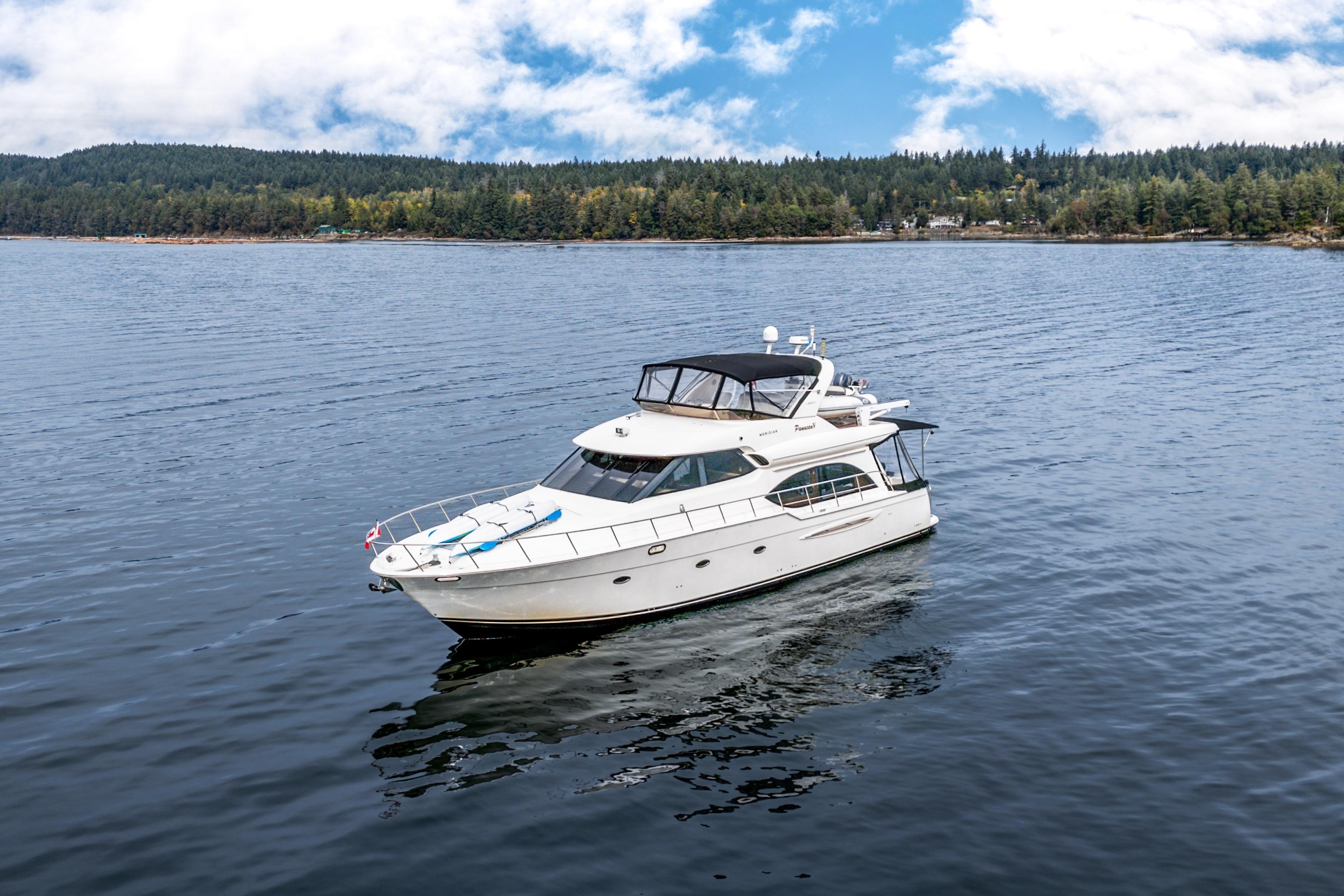 2007 Meridian 580 Pilothouse yacht cruising on a serene lake with forested shoreline.
