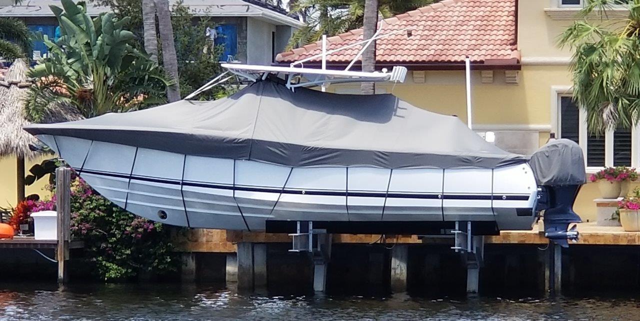 2015 Southport 33 FE boat covered on a dock.