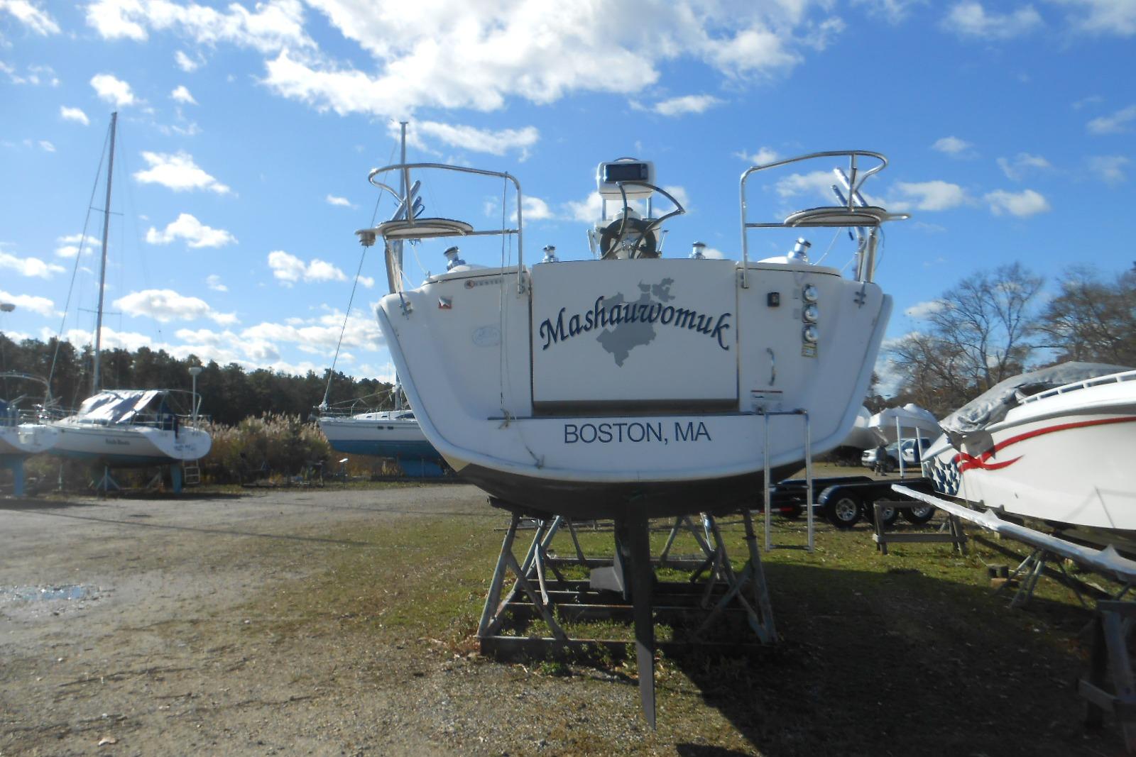 2014 Marlow-Hunter 33 sailboat named Mashauwomuk, docked in Boston, MA, under a clear sky.
