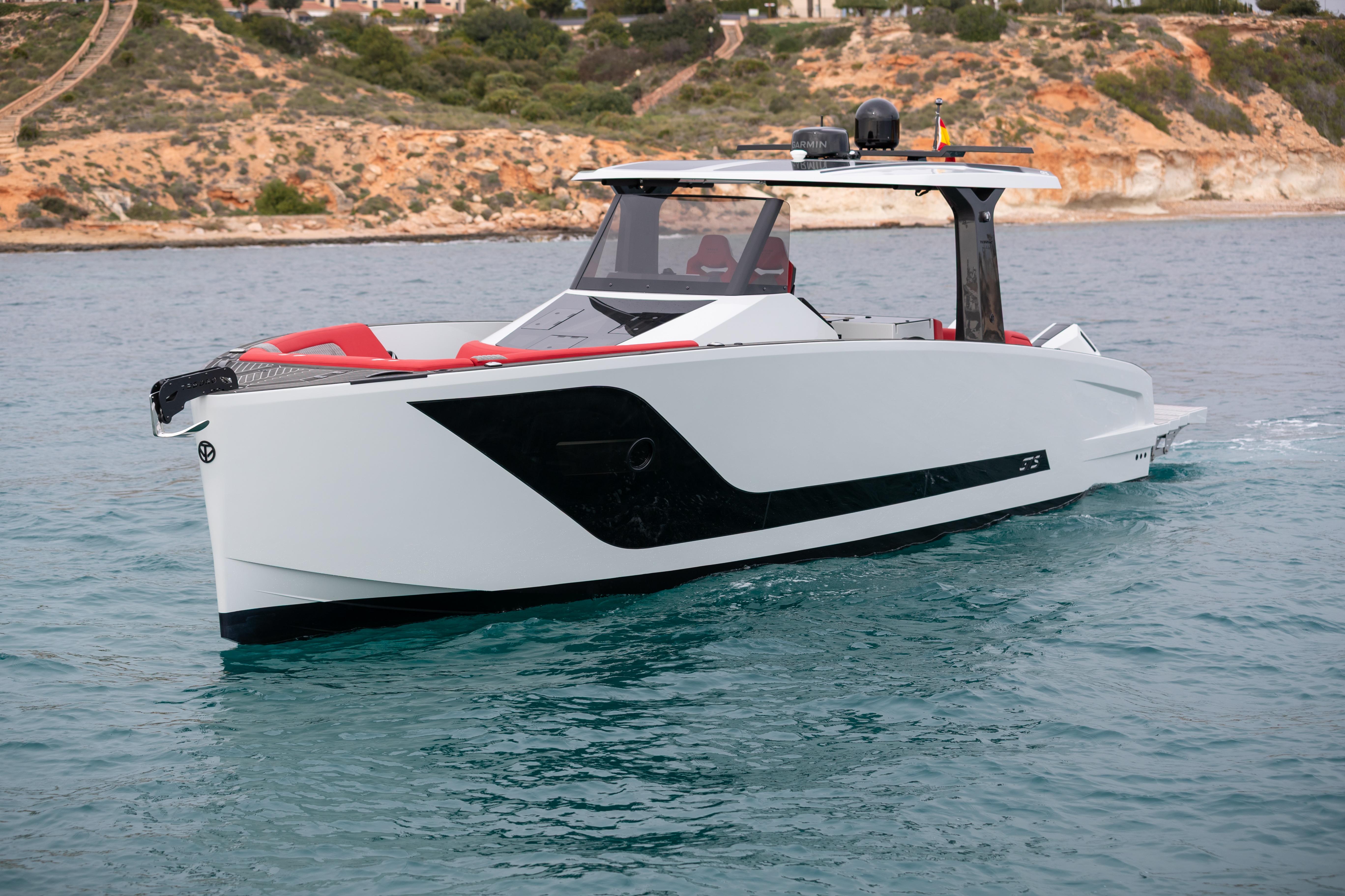 Tesoro 40 GTS 2026 yacht on calm waters near coastal landscape.