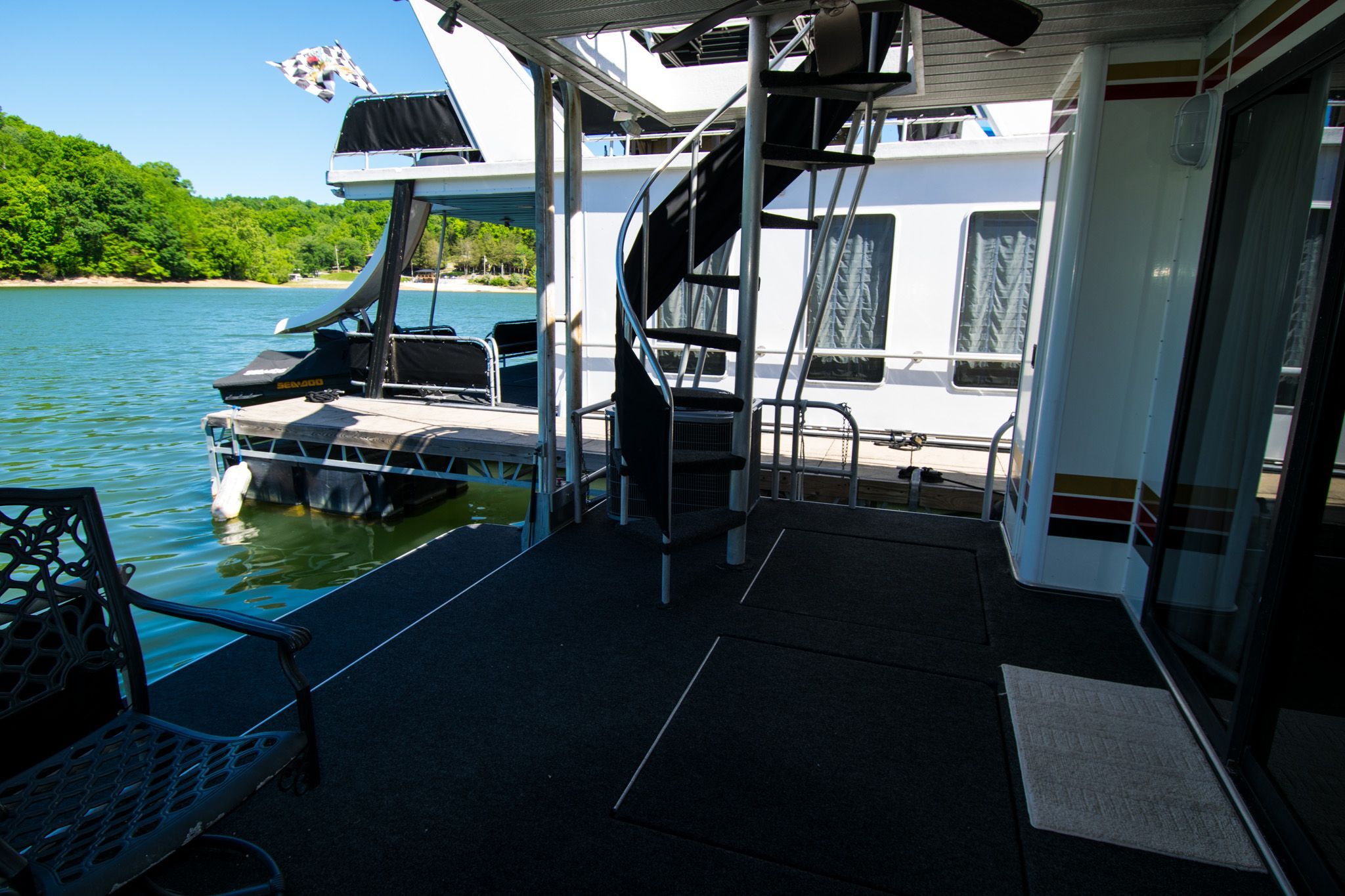 2003 Lakeview 16x70 houseboat with spiral staircase and lake view.