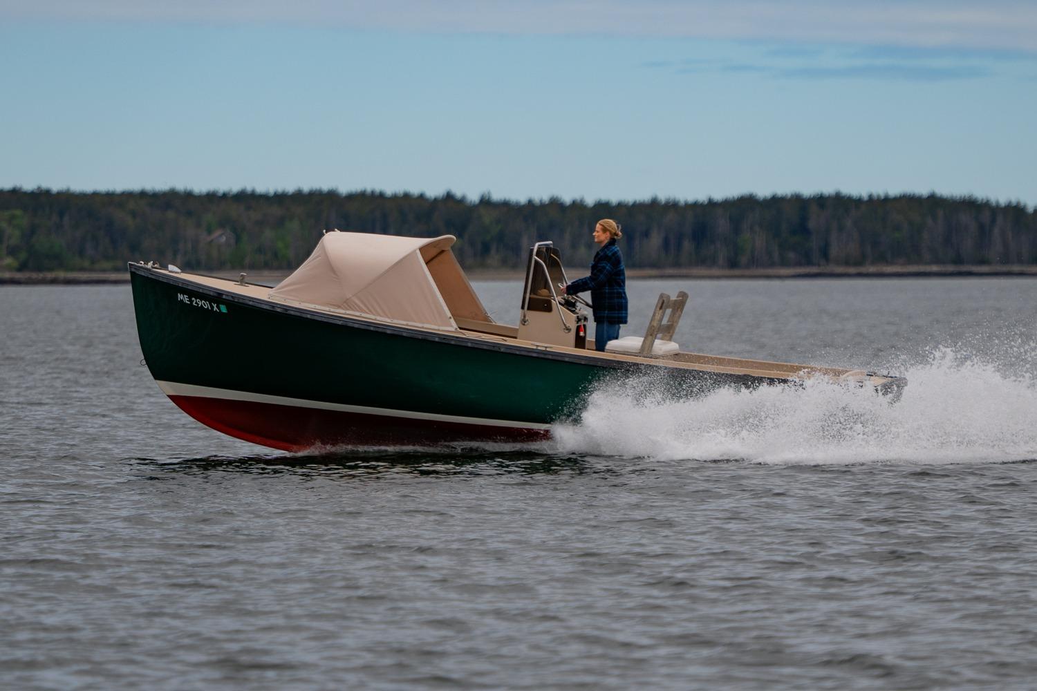 1989 Ellis 24 Open boat cruising on a lake with a person steering.