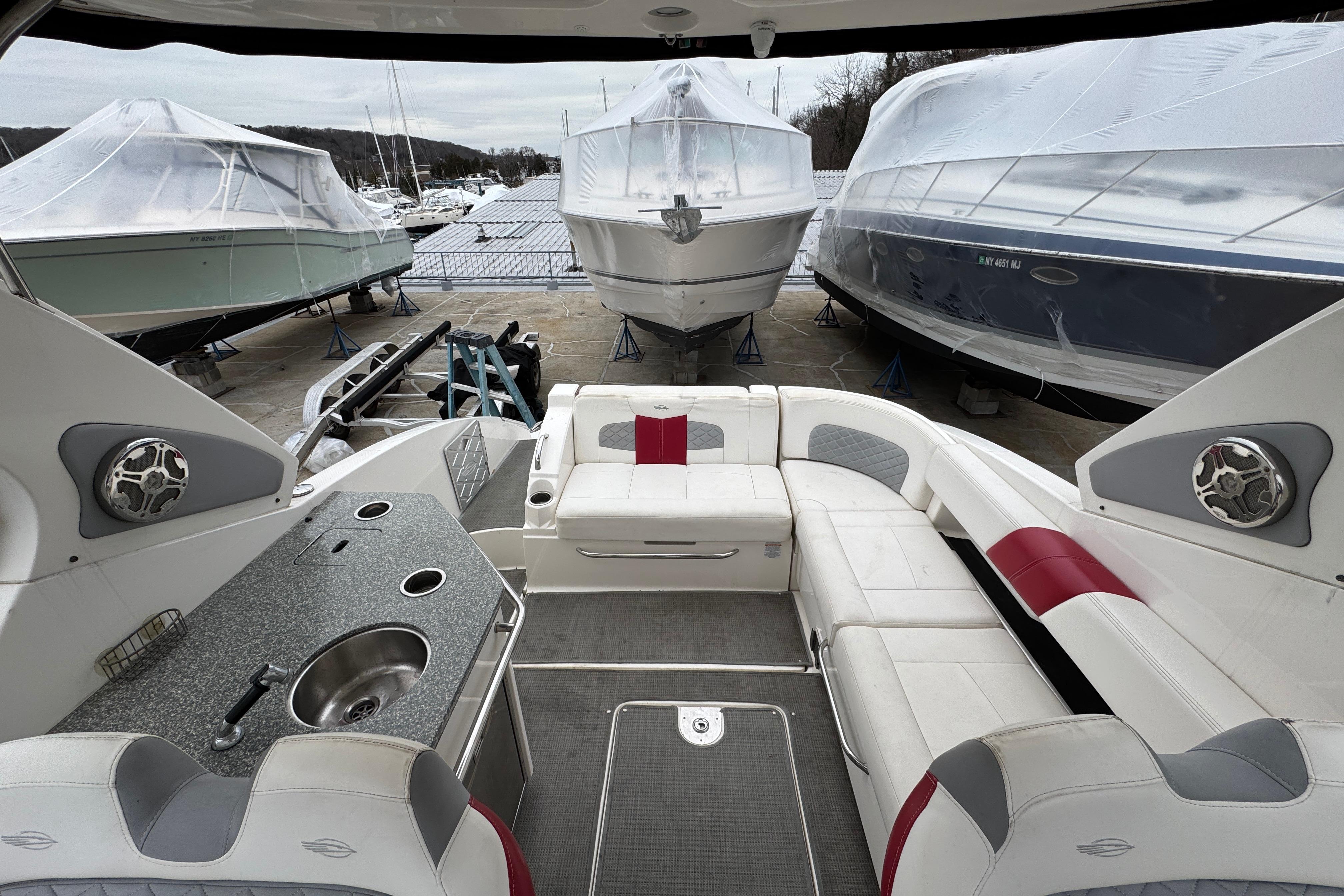 Interior view of 2012 Chaparral 327 SSX boat with seating and kitchenette.