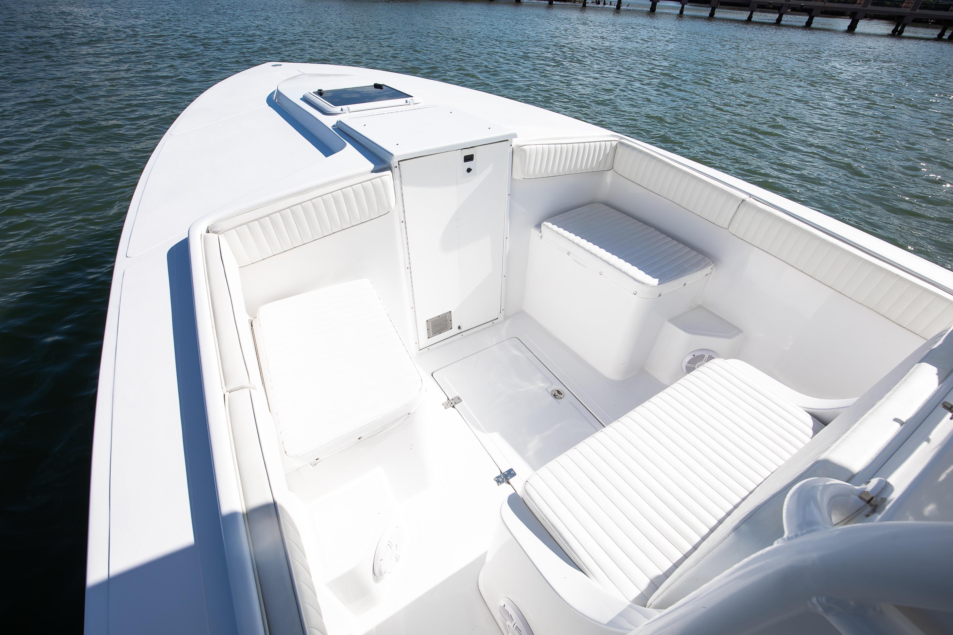 1997 Marlago 35fs boat interior with white seating, docked on calm water.