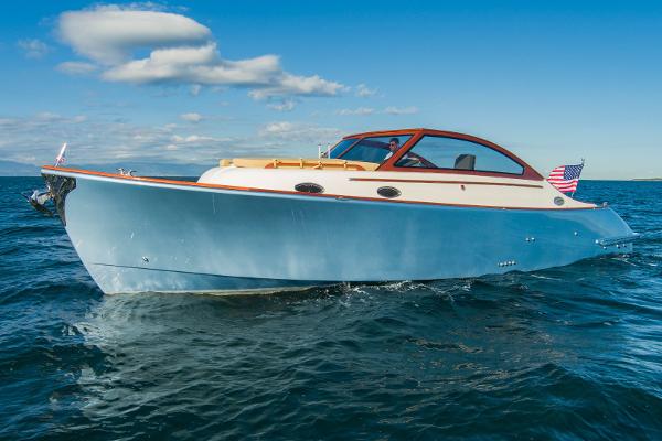 2023 Vento V40 Retro Classic Open boat cruising on the ocean under a clear blue sky.