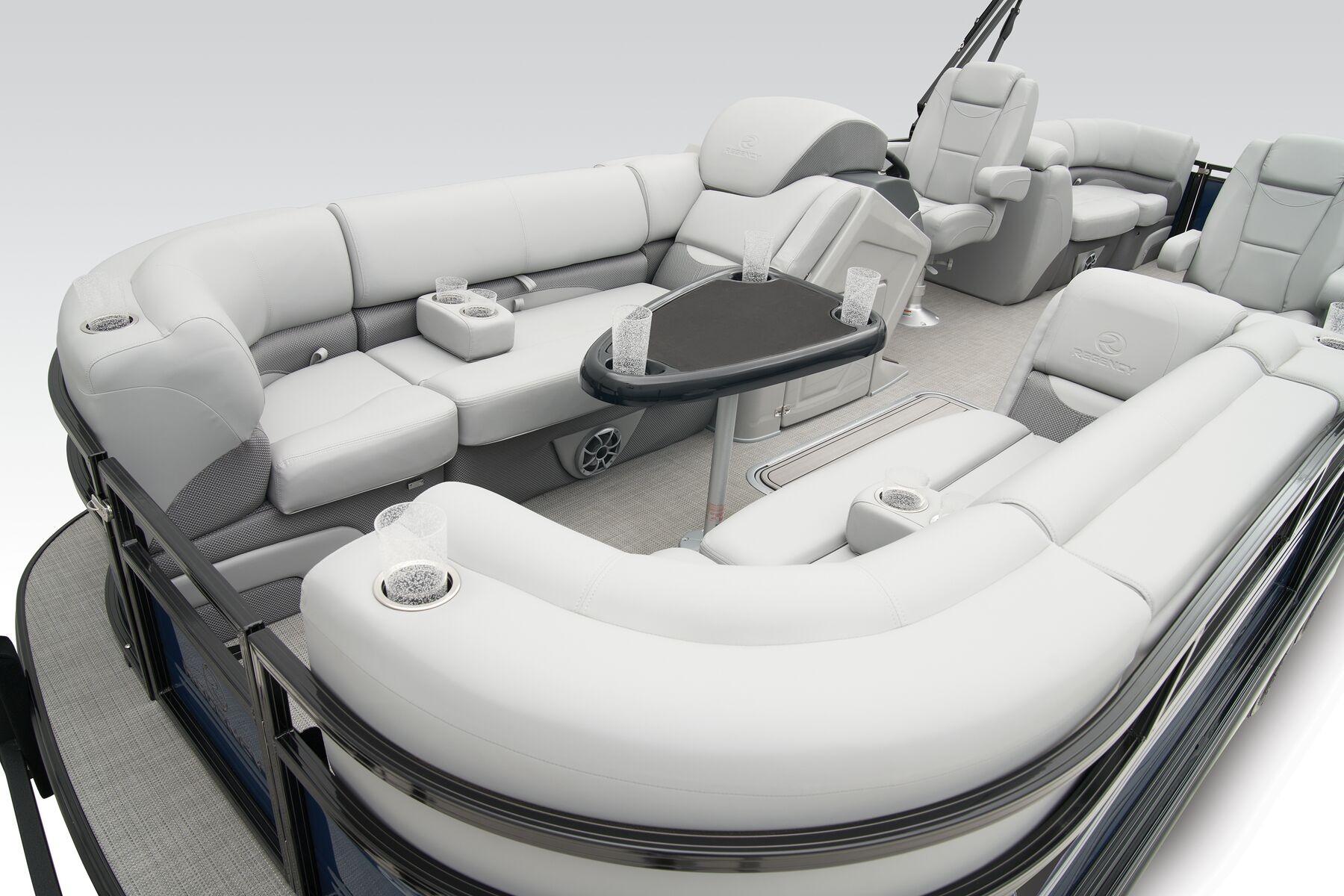 Luxurious 2026 Regency 230 DL pontoon boat interior with plush seating and modern amenities.