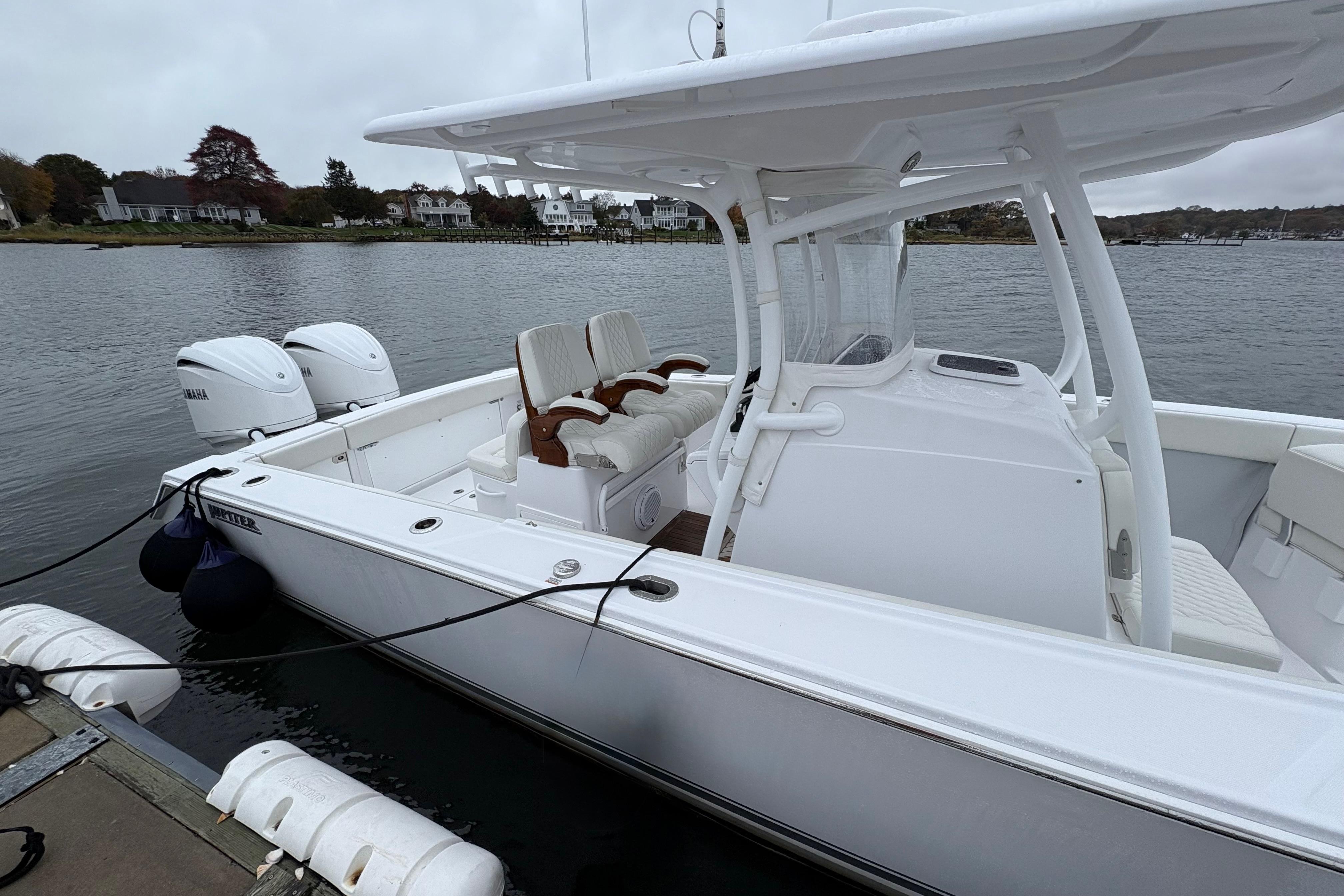 2023 Jupiter 30 boat docked, featuring dual Yamaha engines and sleek white design.