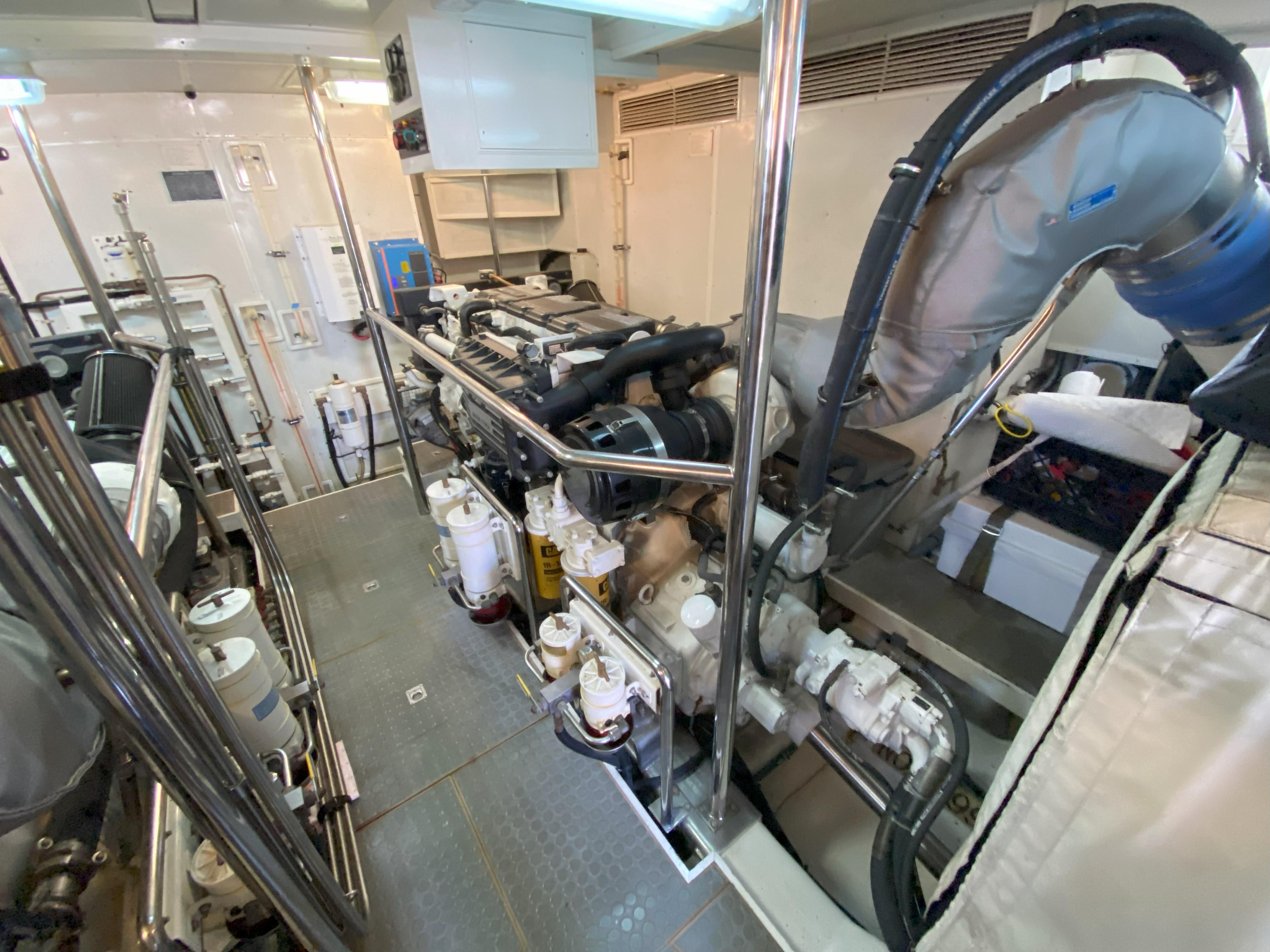 Engine room of a 2005 Offshore Yachts 72', showcasing machinery and equipment.