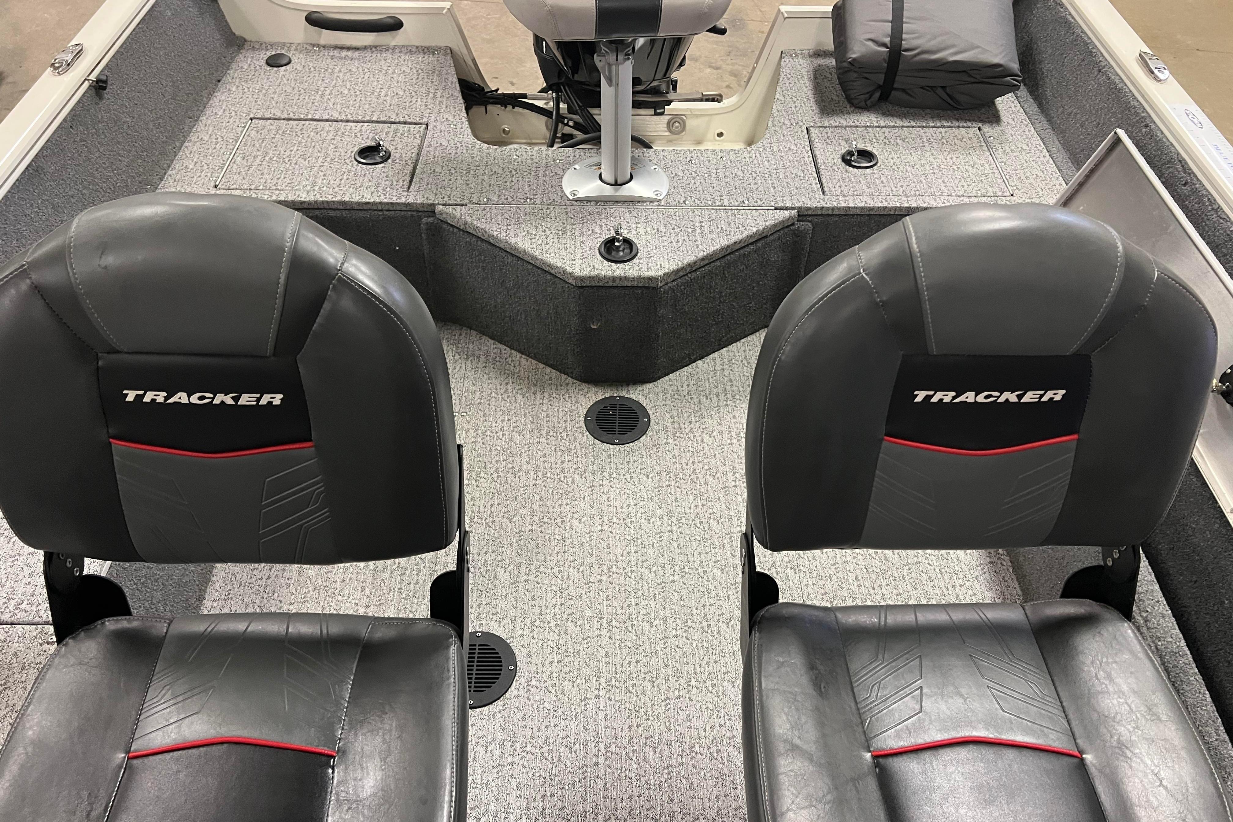 2022 Tracker Pro Guide V-16 WT boat interior with two black seats and gray carpet.