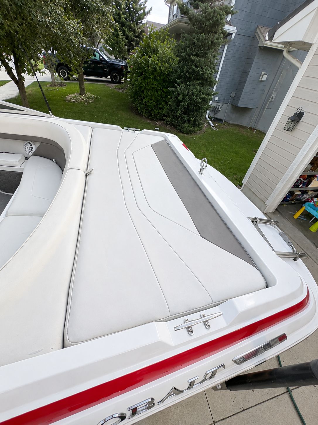 Rear view of a 1995 Cobalt 252 boat in a driveway.