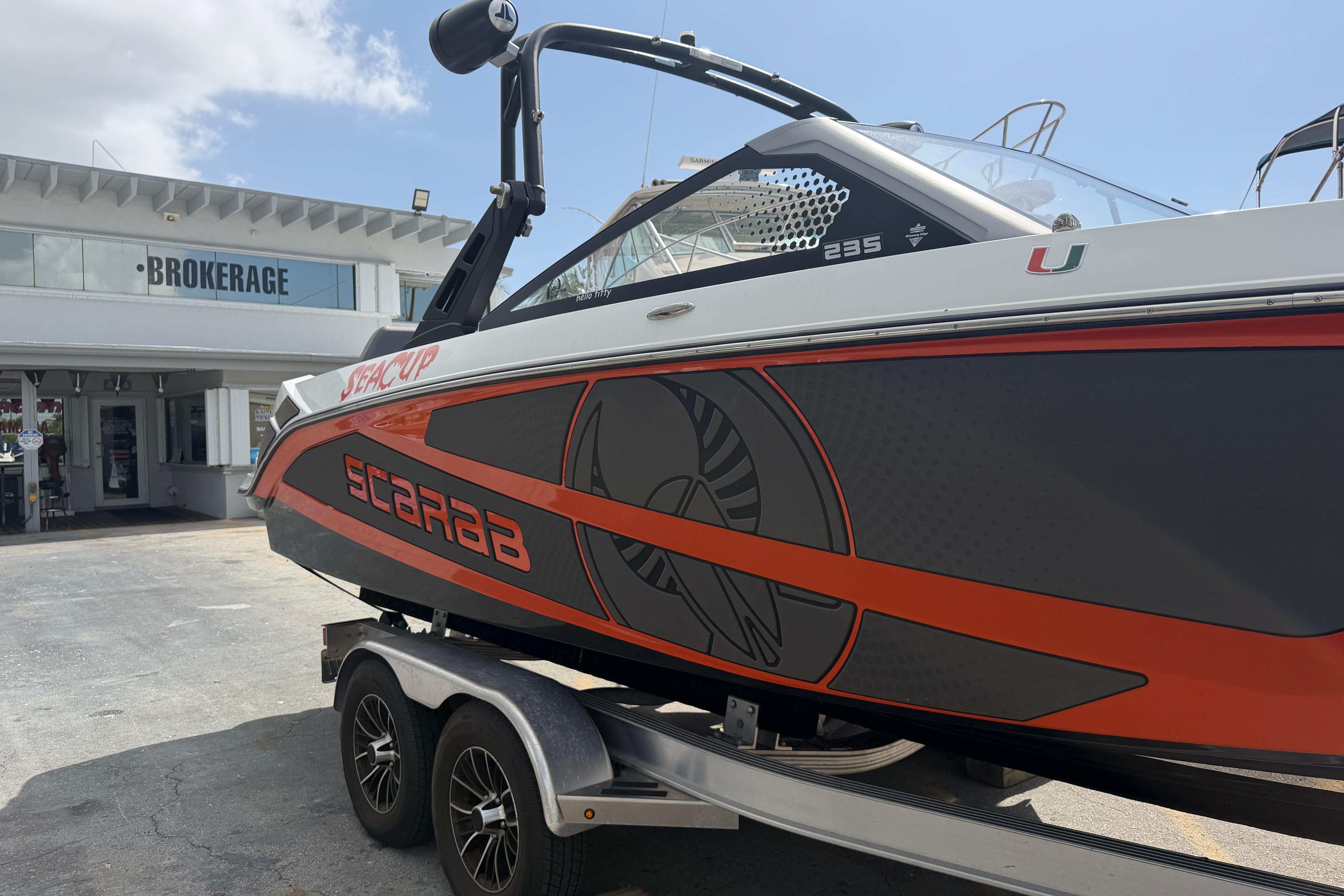 2026 Scarab 235 LX boat on trailer outside brokerage building.
