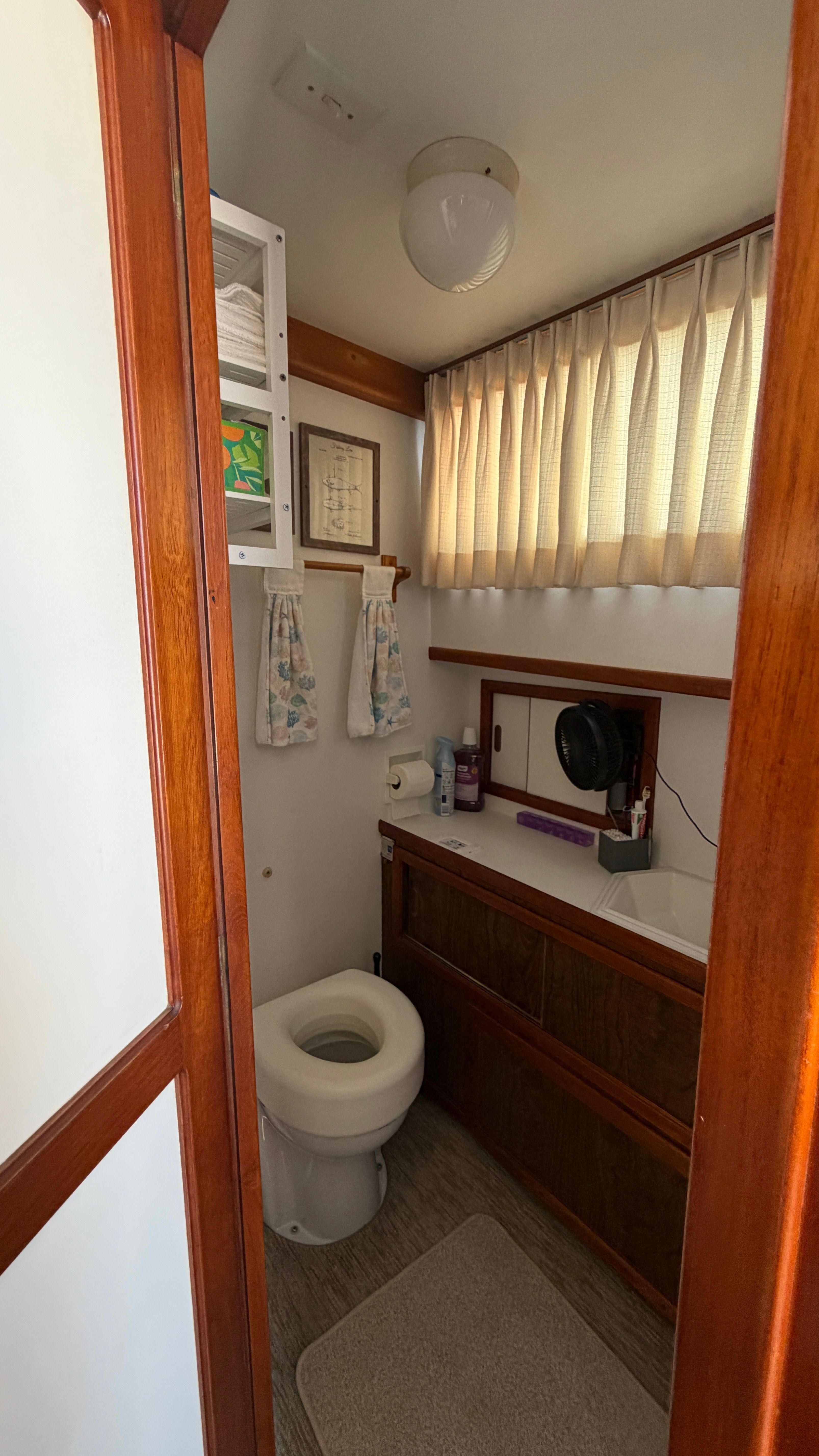 Interior view of a 1966 Yachtfisher bathroom with wooden accents.