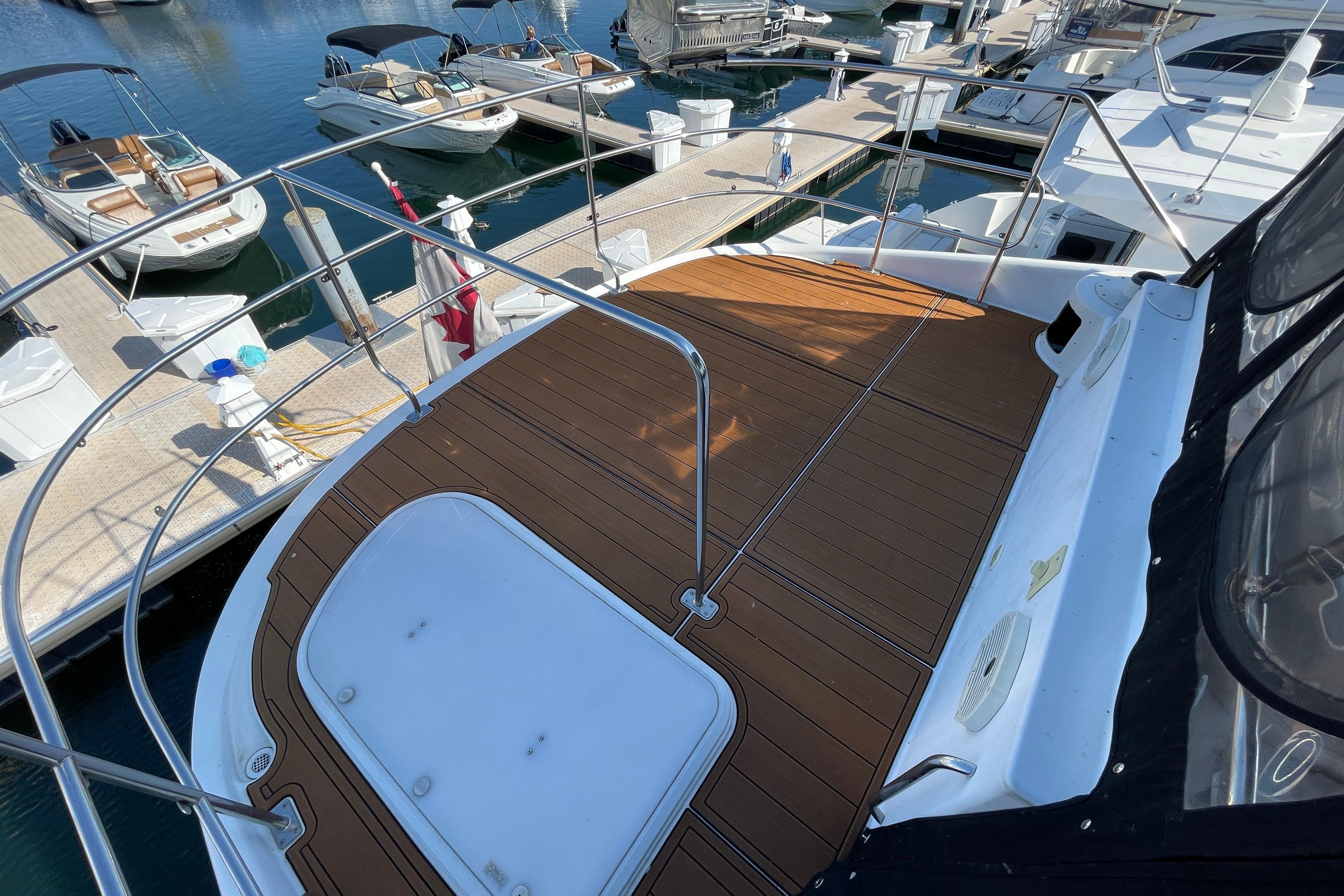 Deck view of 2002 Carver 570 Voyager Pilothouse at marina, surrounded by boats.
